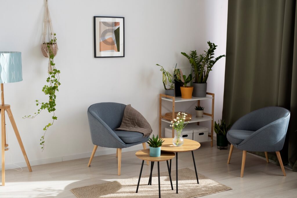 A corner of the living room with few furniture and indoor plants