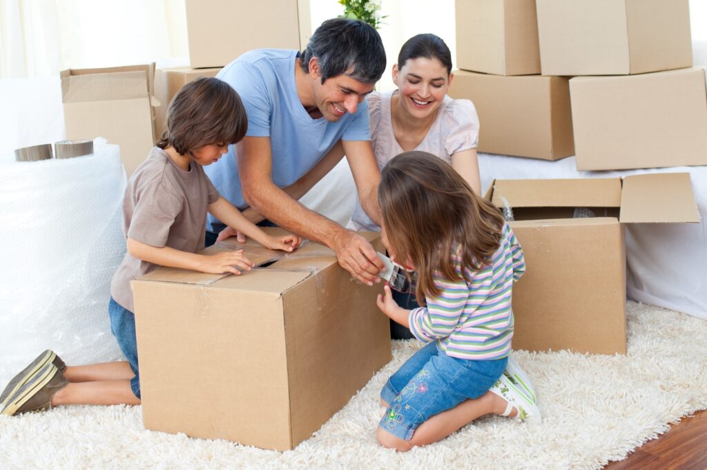 A family happily packing for the house move